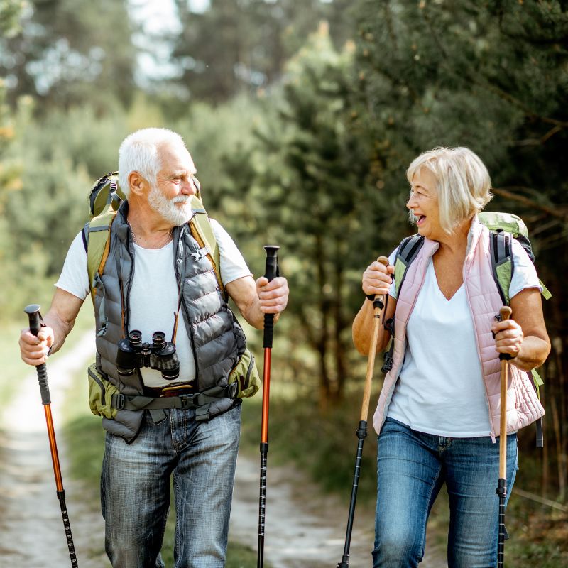 elderly couple hiking in the woods