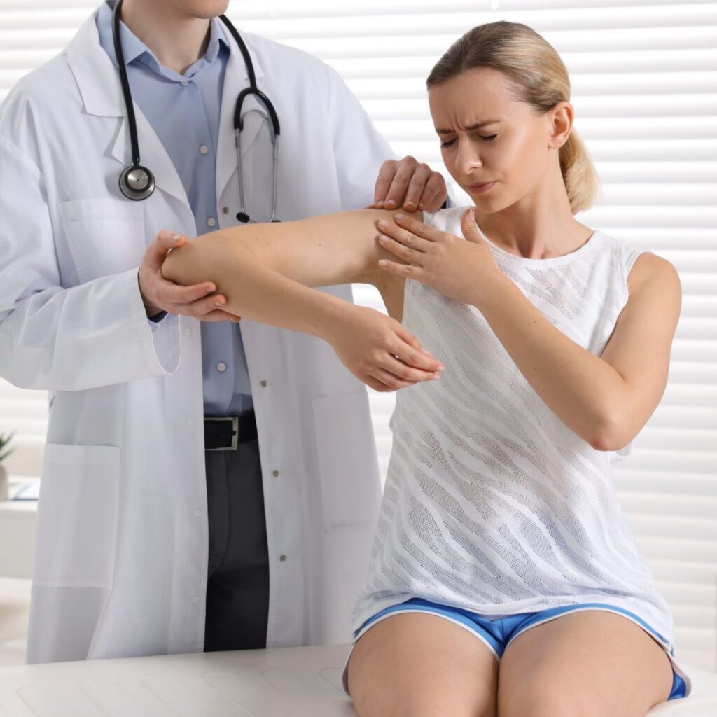 an orthopedic specialist examining a woman's shoulder