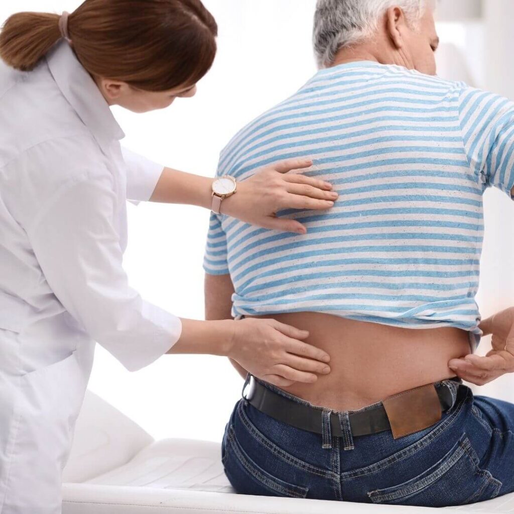 an orthopedic specialist looking at a patient's back